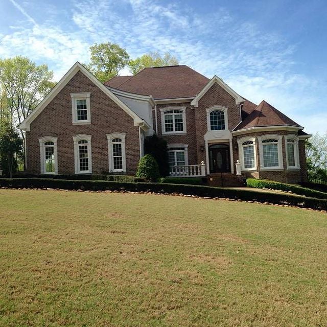 Brick house with a brown roof