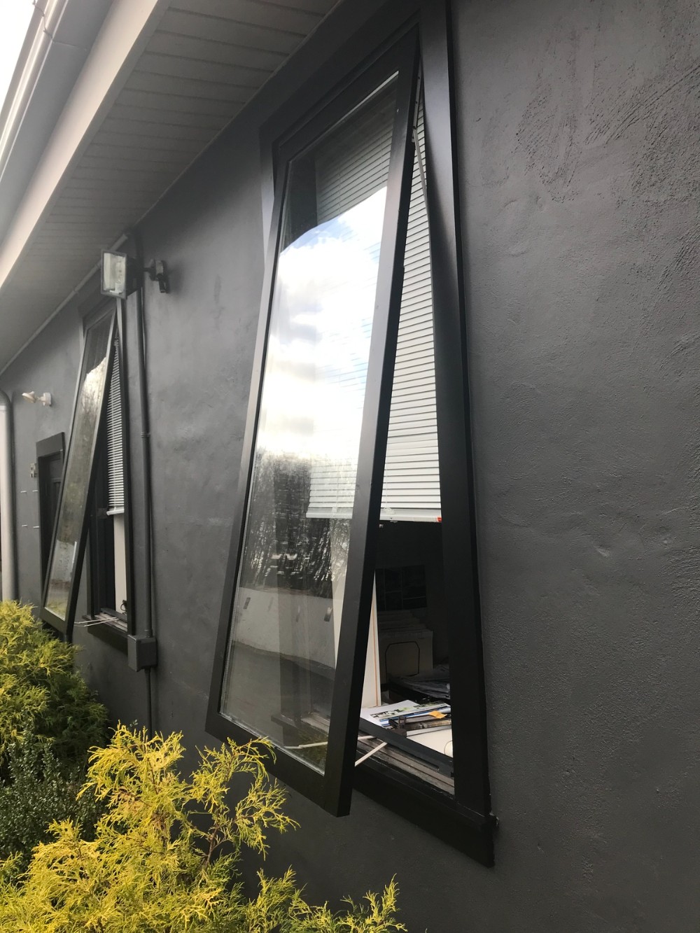 Dark Gray exterior stucco commercial property windows open