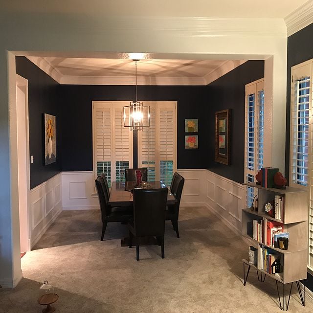 dark green dining room with white accents