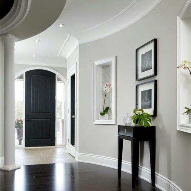 foyer with curved walls and updated grey paint