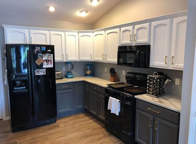 grey and white kitchen with black appliances