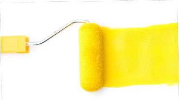 Yellow paint roller following a trail of yellow paint on a white background.