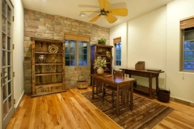 Photo of a warm study with wooden furniture and a wooden floor.