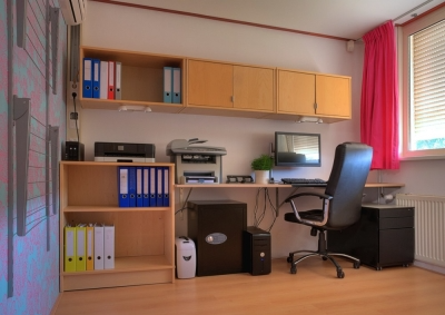 Office with plentiful light wood cabinets for organized storage.