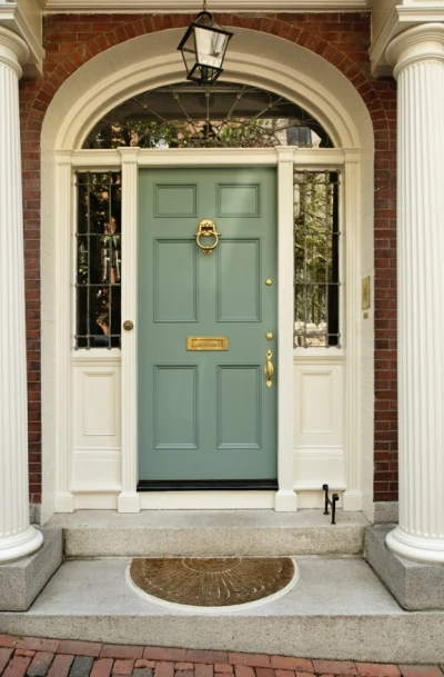 Attractive Front Pork with Olive Green Door, Columns, and Brick Accents.
