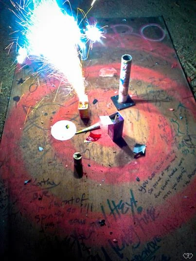 Firework going off on a dirty concrete floor.