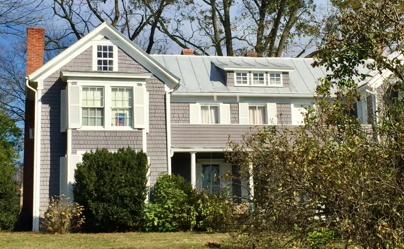 Photo of a two-story house with a front yard.