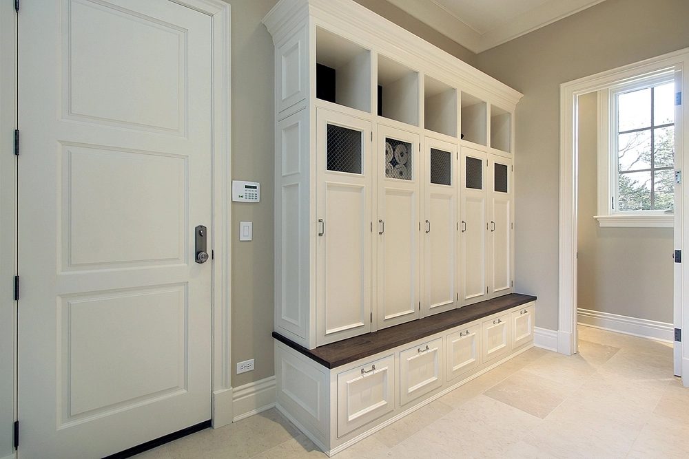 White cabinets against beige wall.
