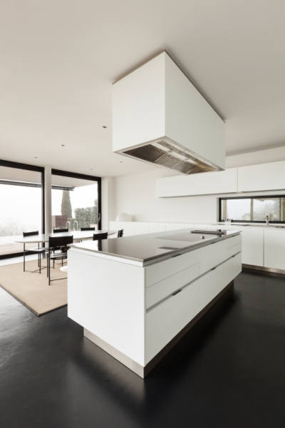 White Kitchen Walls and Cabinets Prevent a Room with Dark Accents from Feeling Small.  