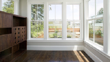 Room with wooden furniture, wooden floor, and white accents.