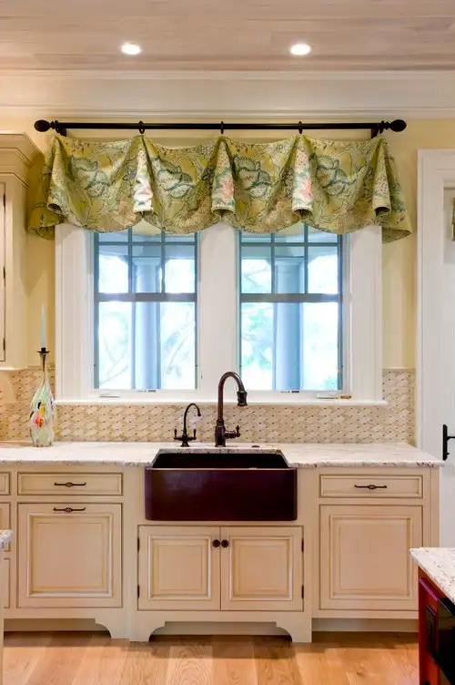 Kitchen sink in front of a window.