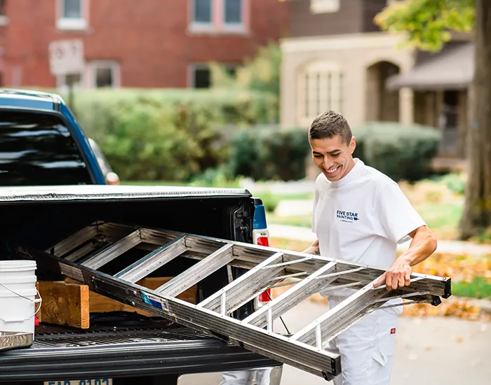 Five Star Painting professional removing ladder of car before an appointment.