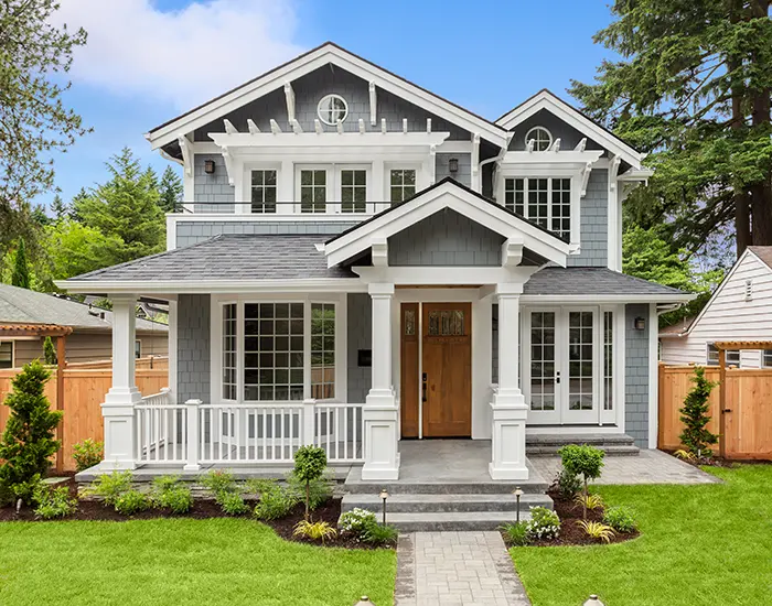 Grey and white Craftsman style house after exterior carpentry services from Five Star Painting 