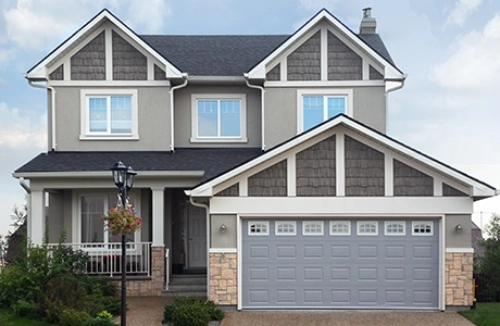 A freshly painted two story home in shades of brown, tan and grey.
