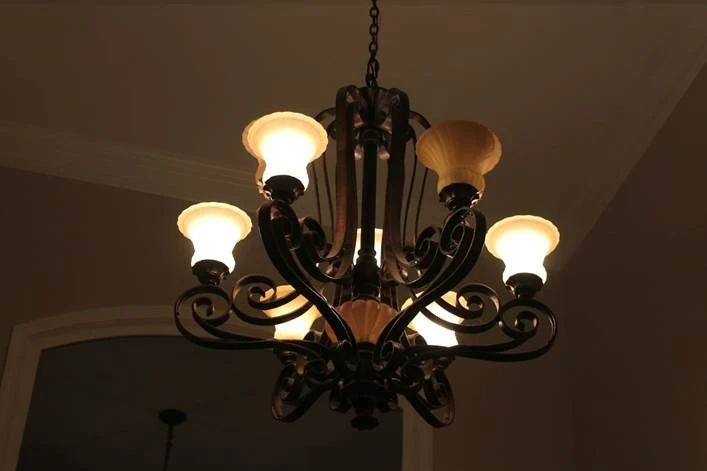 Photo of lighted chandelier in a darkened room.