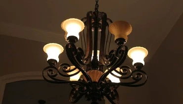 Photo of lighted chandelier in a darkened room.